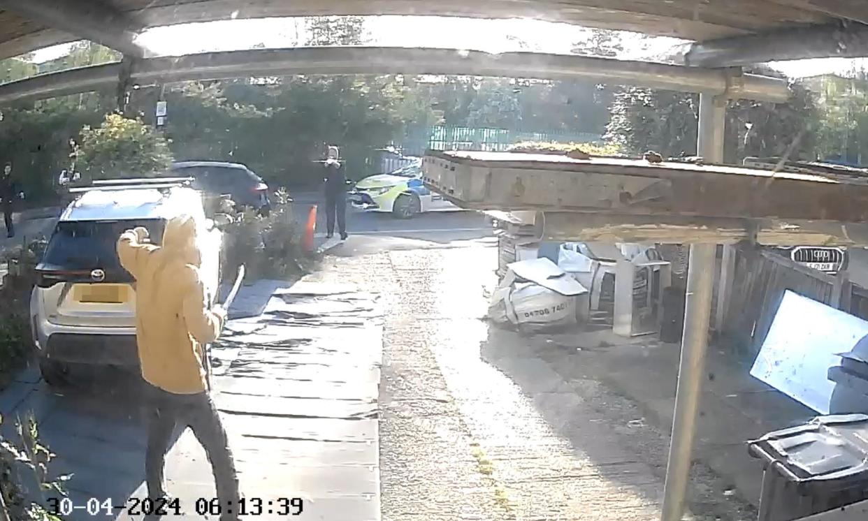 <span>Footage from a doorbell camera of police officers using a Taser gun on the sword-wielding man in Hainault, north east London.</span><span>Photograph: PA</span>