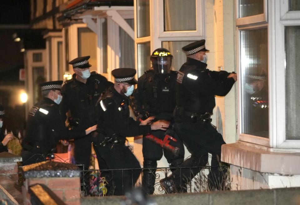 Merseyside Police make an early morning raid on a home in Liverpool, watched by Prime Minister Boris Johnson (Christopher Furlong/PA) (PA Wire)