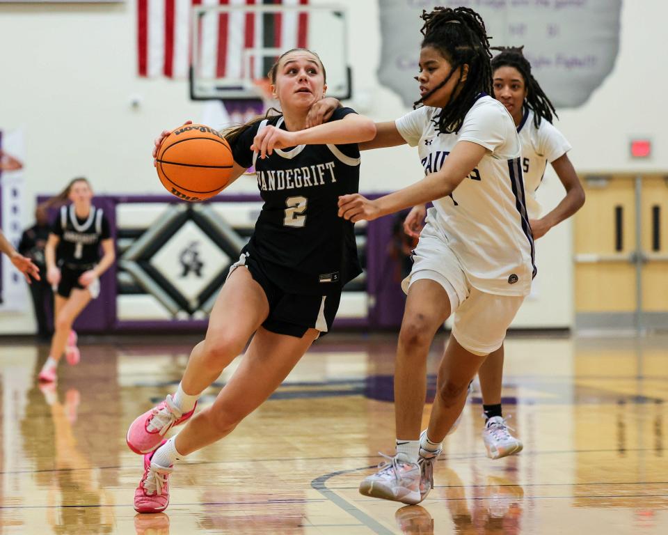 Maddie Broxterman (2) drives to score for Vandegrift against Cedar Ridge late in the second half of a tight district game Jan. 12, 2023, at Cedar Ridge High School. After several lead swaps, Vandegrift squeezed out a 45-43 win over district-leader Cedar Ridge.