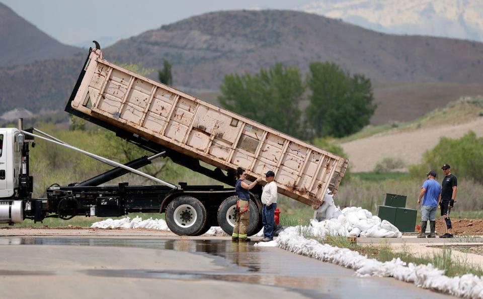 A dump truck unloads sandbags to contain flooding in Santaquin on Wednesday, May 17, 2023. | Kristin Murphy, Deseret News