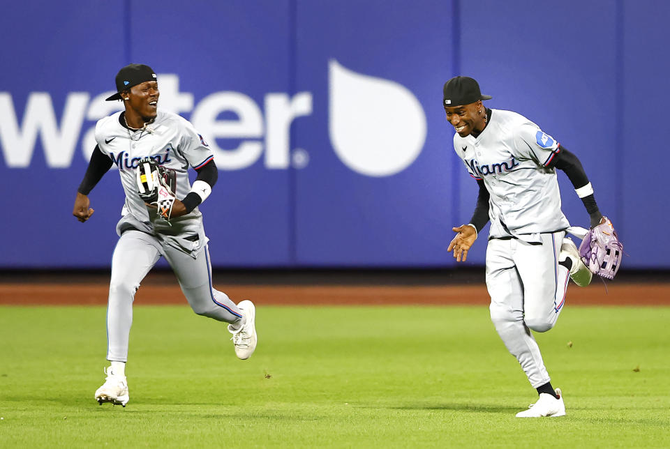 Miami Marlins outfielders Jazz Chisholm Jr., left and Nick Gordon, right, run to the dugout after during the ninth inning of a baseball game, Tuesday, June 11, 2024, in New York. (AP Photo/Noah K. Murray)