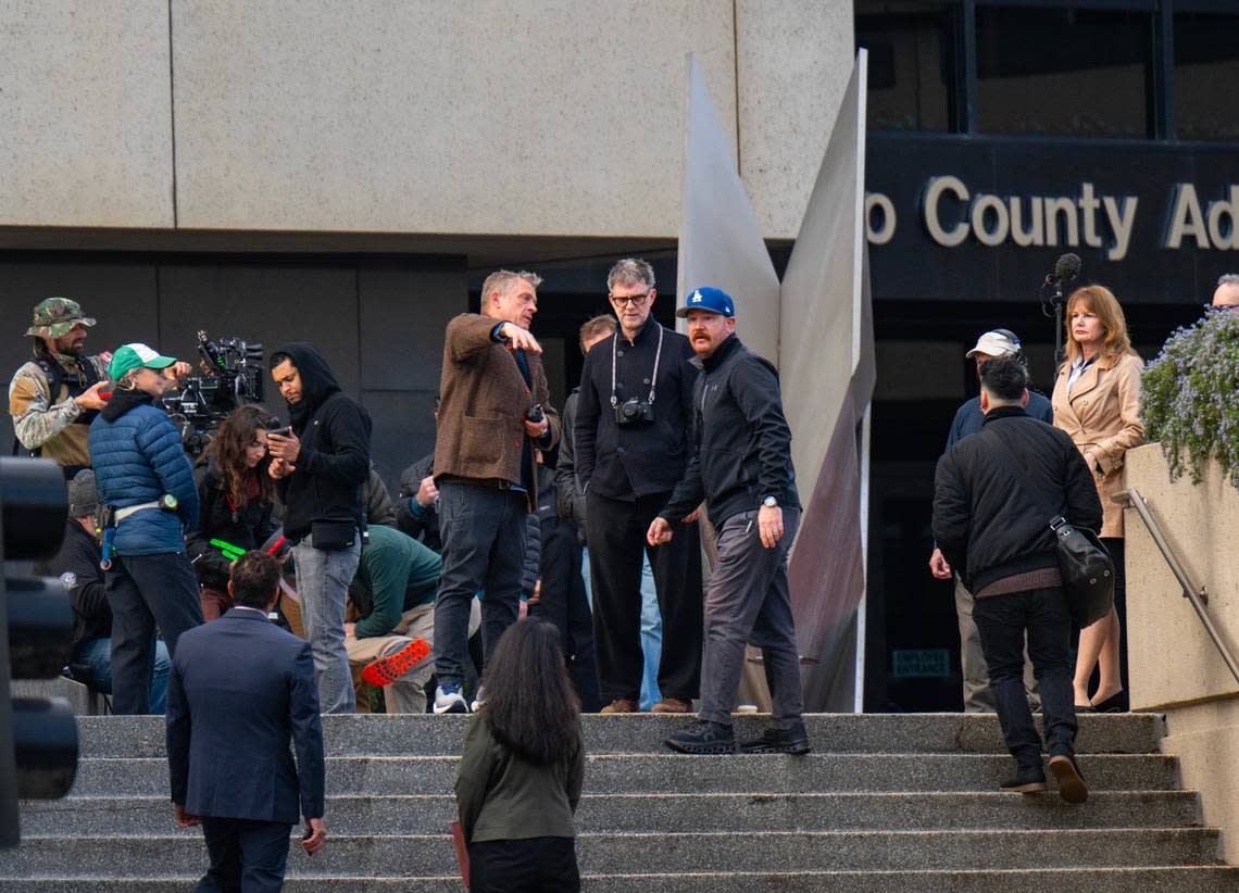 Director Paul Thomas Anderson, center, prepares to film a scene for an upcoming movie at the Sacramento County Administration Building in downtown on Saturday.