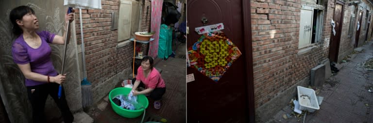 An abandoned sink lies on the pavement in front of a home where a woman once hung shirts while another woman washed clothes in a green plastic bucket