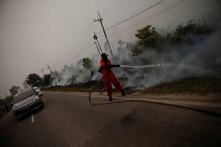 The Wider Image: Indonesia's firefighters on frontline of Borneo's forest blazes