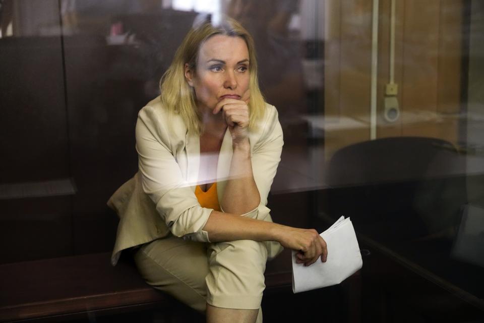 Marina Ovsyannikova, a former Russian state TV journalist who quit after making an on-air protest of Russia's military operation in Ukraine, listens sitting in a court room during a hearing in Moscow, Russia, Thursday, Aug. 11, 2022. A court in Russia on Thursday ordered to place Ovsyannikova under house arrest for nearly two months pending investigation and trial on the charges of spreading false information about Russia's armed forces. If convicted, Ovsyannikova faces up to 10 years in prison under a new law that penalizes statements against the military and that was enacted shortly after Russian troops moved into Ukraine. (AP Photo/Alexander Zemlianichenko)