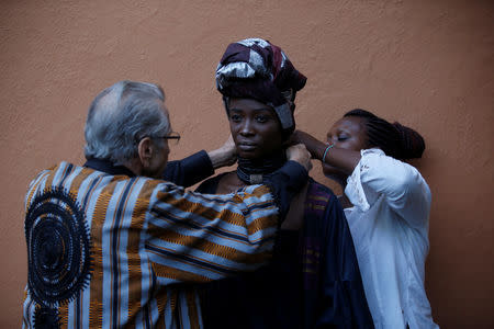 A model receives final touches behind the scenes, before a fashion show featuring African fashion and culture, during a gala marking the launch of a book called "African Twilight: The Vanishing Rituals and Ceremonies of the African Continent" at the African Heritage House in Nairobi, Kenya March 3, 2019. REUTERS/Baz Ratner
