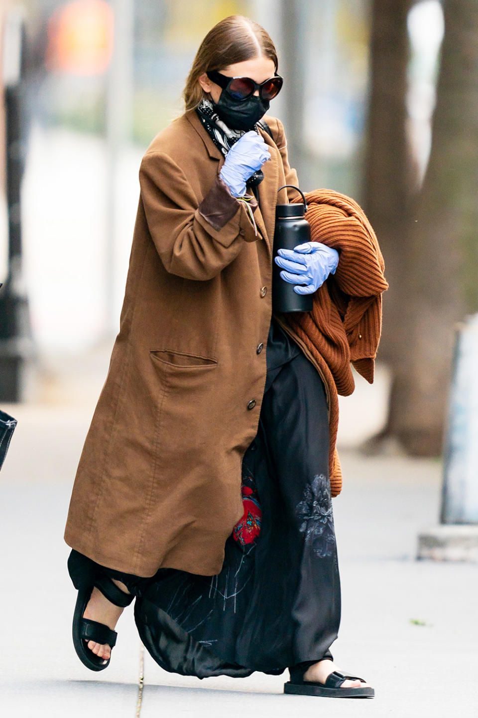 <p>Ashley Olsen is seen dressed in a long coat and black strappy sandals on Thursday in N.Y.C. following news of sister Mary-Kate's divorce news. </p>