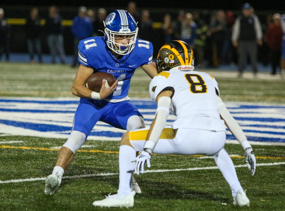 Caldwell's Louie Anemone runs the ball as Cedar Grove's Nick Droge defends during the first half of a football game at Caldwell High School on Oct. 14, 2022.