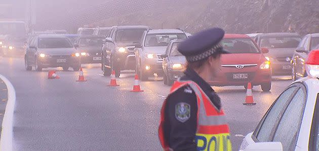 Police directing traffic around the crash on the South Eastern Freeway.