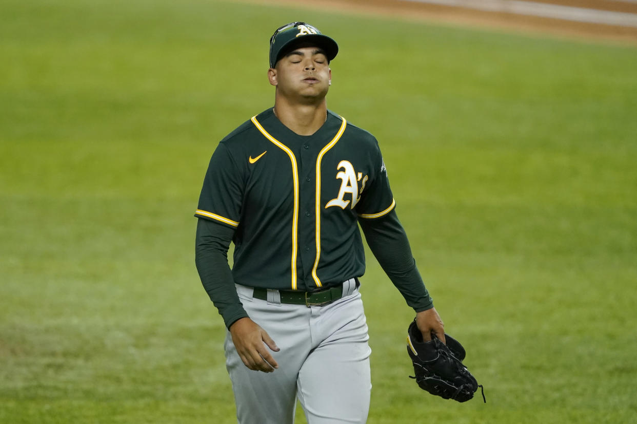 Oakland Athletics starting pitcher Jesus Luzardo lets out a deep breath as he walks to the dugout after being pulled in the seventh inning of a baseball game against the Texas Rangers in Arlington, Texas, Monday, Aug. 24, 2020. (AP Photo/Tony Gutierrez)