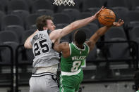 Boston Celtics guard Kemba Walker (8) is blocked by San Antonio Spurs center Jakob Poeltl (25) as he tries to score during the second half of an NBA basketball game in San Antonio, Wednesday, Jan. 27, 2021. (AP Photo/Eric Gay)