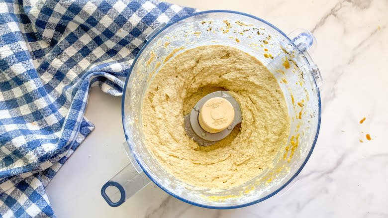 food processor beside blue checkered towel