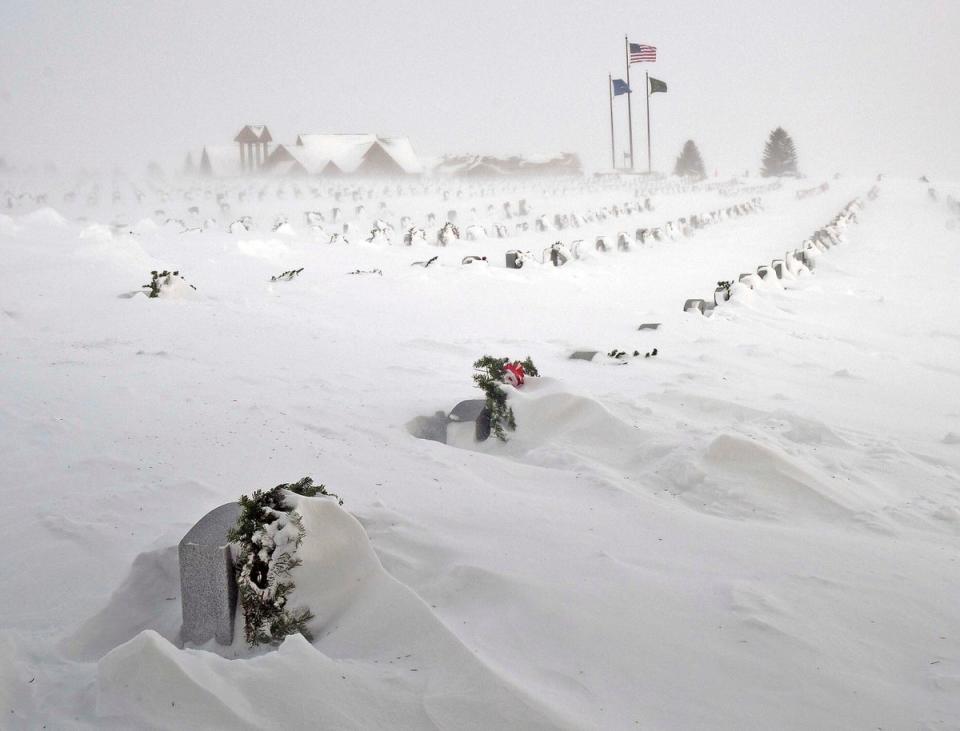 Rows of headstones at the North Dakota Veterans Cemetery are blanketed by drifting snow Thursday (AP)