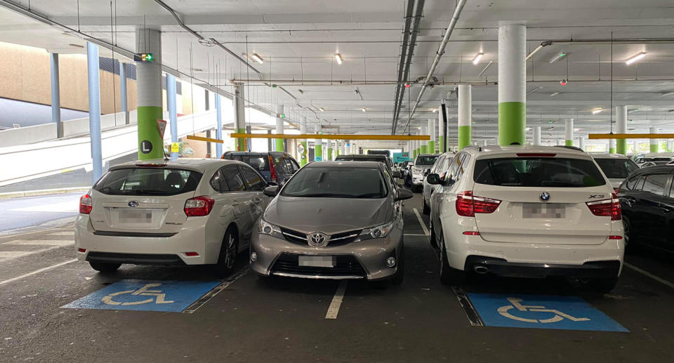 A car parked between to others illegally in a disabled parking bay at Westfield Eastgardens. 