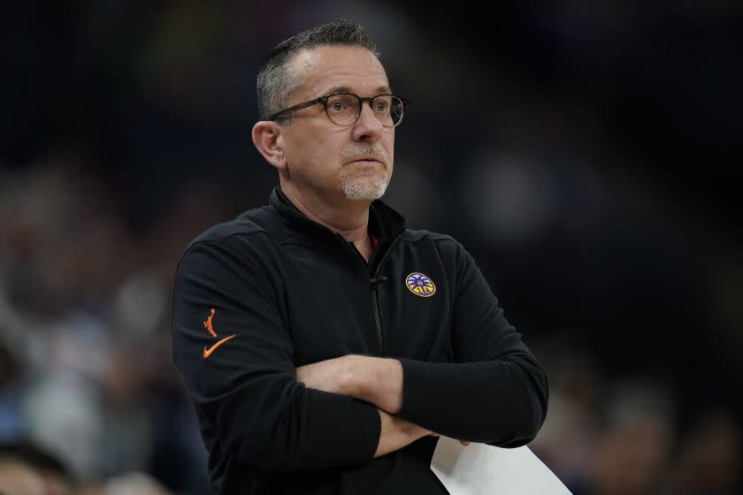 Los Angeles Sparks head coach Curt Miller watches play during the first half of a WNBA basketball game.