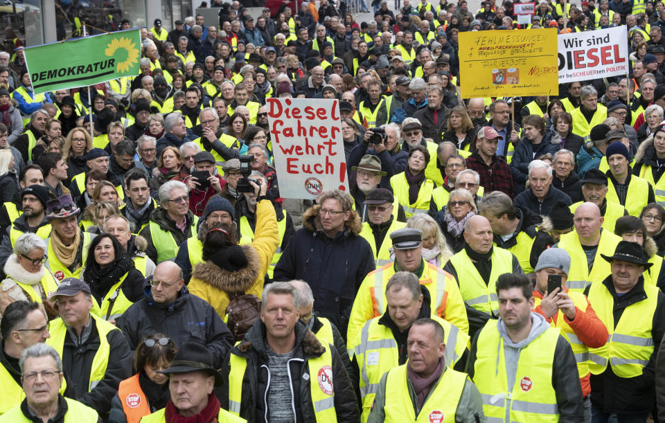 Protesters wearing yellow vests hold a banner reading ‘Diesel drivers resist!’ during a demonstration against driving ban for older diesels, in Stuttgart, southwestern Germany. Photo: Thomas Kienzle/AFP/Getty