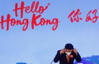 Hong Kong Chief Executive John Lee adjusts his protective mask after "Hello Hong Kong" campaign event to promote city tourism in Hong Kong