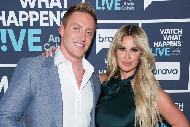 <p>Charles Sykes/Bravo/NBCU Photo Bank/NBCUniversal via Getty</p> Kroy Biermann and Kim Zolciak pose at Watch What Happens Live with Andy Cohen.