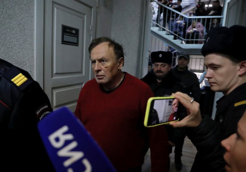 Russian historian Sokolov is escorted before a court hearing in Saint Petersburg