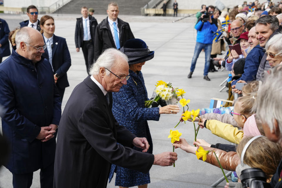 Sweden's King Carl XVI Gustaf, centre left, Queen Silvia, centre, and Estonian President Alar Karis, left, receive flowers as they attend an official welcoming ceremony at Vabaduse (Freedom) square in Tallinn, Estonia, Tuesday, May 2, 2023. (AP Photo/Pavel Golovkin)