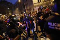 Right wing pro-Spanish unity supporters challenge police officers during a demonstration in Barcelona, Spain, Thursday, Oct. 17, 2019. Catalonia's separatist leader vowed Thursday to hold a new vote to secede from Spain in less than two years as the embattled northeastern region grapples with a wave of violence that has tarnished a movement proud of its peaceful activism. (AP Photo/Bernat Armangue)