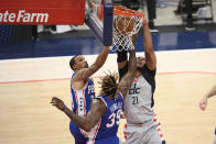 Washington Wizards center Daniel Gafford (21) dunks over Philadelphia 76ers center Dwight Howard (39) and guard George Hill (33) during the first half of Game 3 in a first-round NBA basketball playoff series, Saturday, May 29, 2021, in Washington. (AP Photo/Nick Wass)