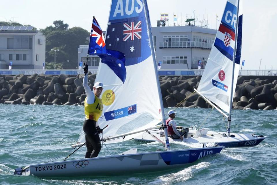 Australia’s Matt Wearn celebrates after placing first in the men’s laser medal race.