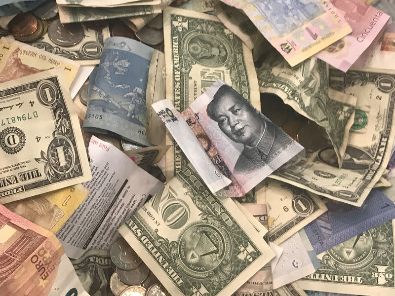 U.S. dollars and other world currencies lie in a charity receptacle at Pearson international airport in Toronto, Ontario, Canada June 13, 2018. REUTERS/Chris Helgren