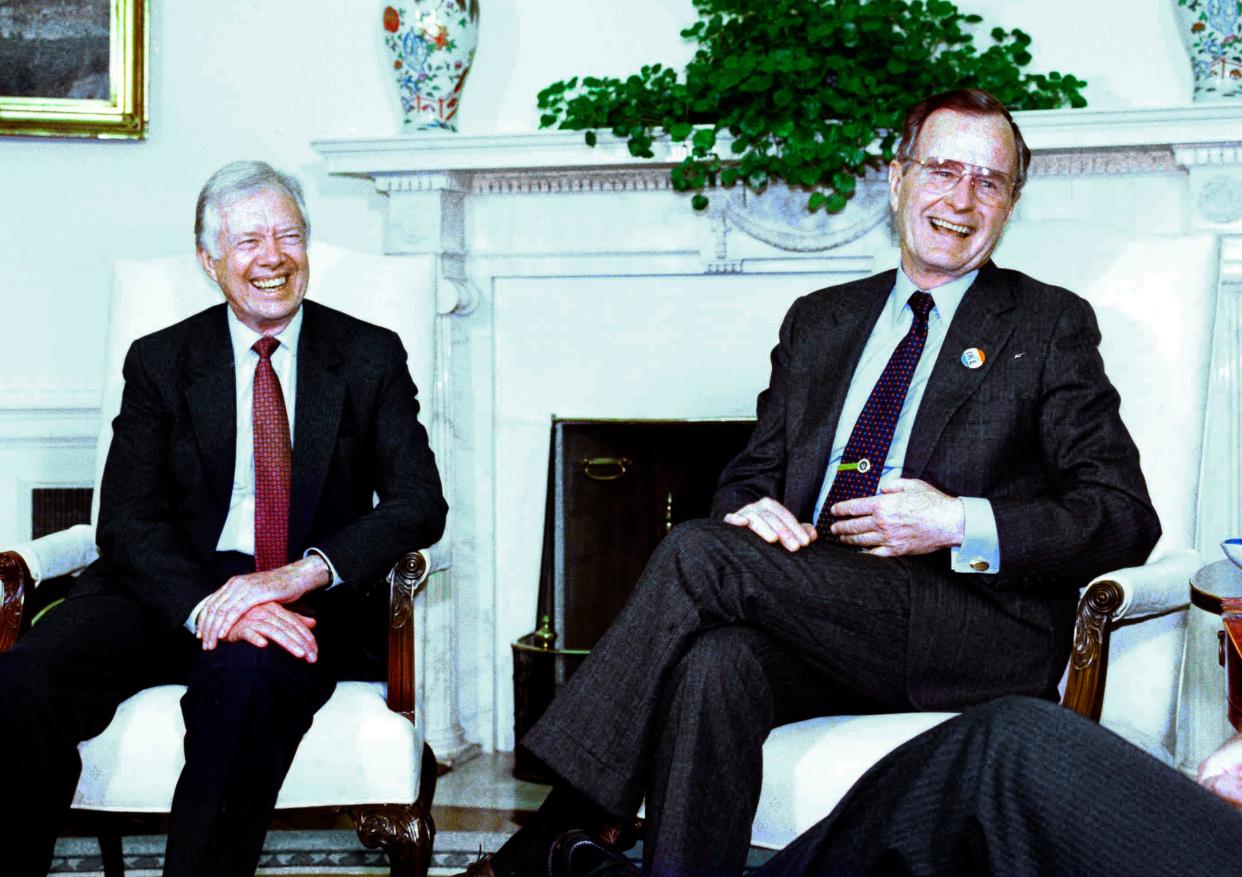 President George Bush meets in the Oval Office at the White House in Washington, March 27, 1990, with former President Jimmy Carter.