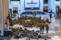 Hundreds of National Guard troops hold inside the Capitol Visitor's Center to reinforce security at the Capitol in Washington, Wednesday, Jan. 13, 2021. The House of Representatives is pursuing an article of impeachment against President Donald Trump for his role in inciting an angry mob to storm the Capitol last week. (AP Photo/J. Scott Applewhite