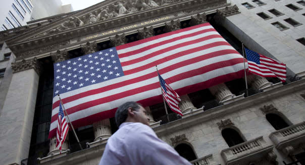 FILE - In this Monday, Aug. 8, 2011, file photo, a pedestrian walks past the New York Stock Exchange in New York. U.S. stocks headed higher in early trading, Friday, May 1, 2015, as the market bounces back from a steep decline the day before. Most Asian and European markets are closed for May 1, known as Labour Day in most of the world. (AP Photo/Jin Lee, File)