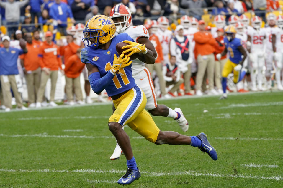 Pittsburgh wide receiver Taysir Mack (11) runs away from Clemson linebacker Barrett Carter (0) on his way to a touchdown during the first half of an NCAA college football game, Saturday, Oct. 23, 2021, in Pittsburgh. (AP Photo/Keith Srakocic)