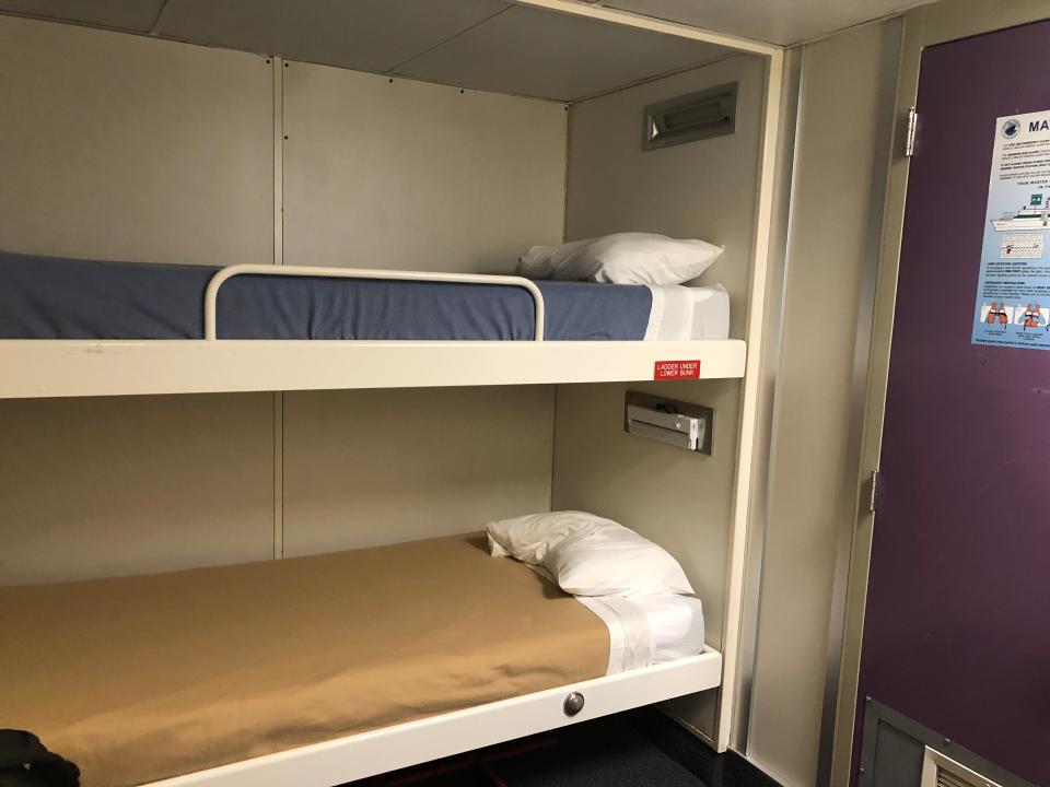 A ship cabin with two bunk-style beds.