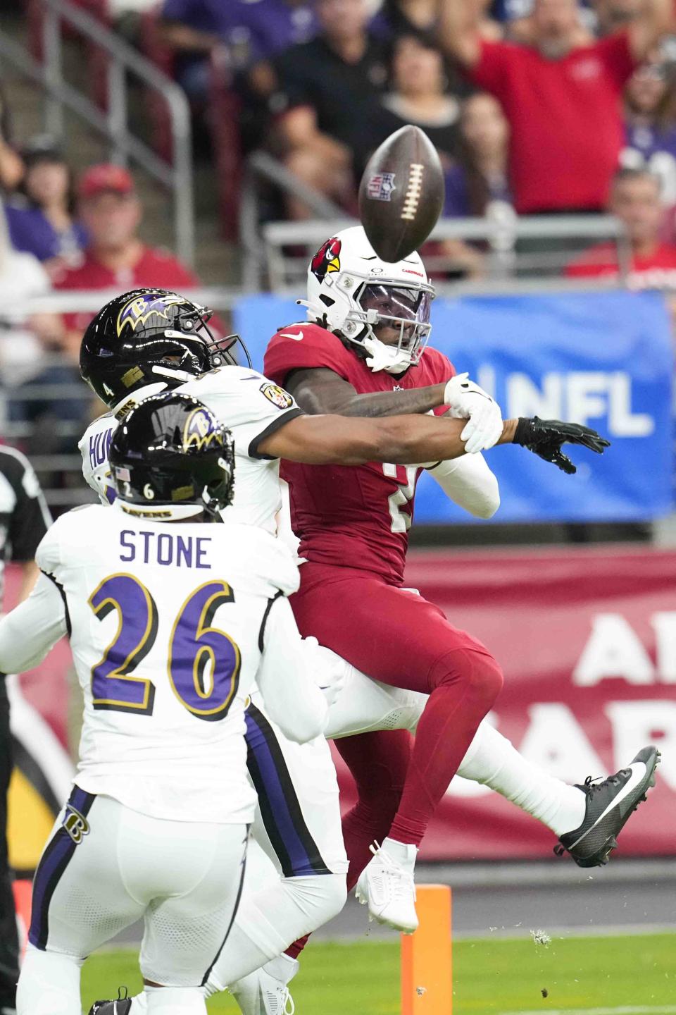 Baltimore Ravens' Marlon Humphrey, top left, disrupts a pass intended for Arizona Cardinals wide receiver Marquise Brown during the first half of an NFL football game Sunday, Oct. 29, 2023, in Glendale, Ariz. (AP Photo/Ross D. Franklin)