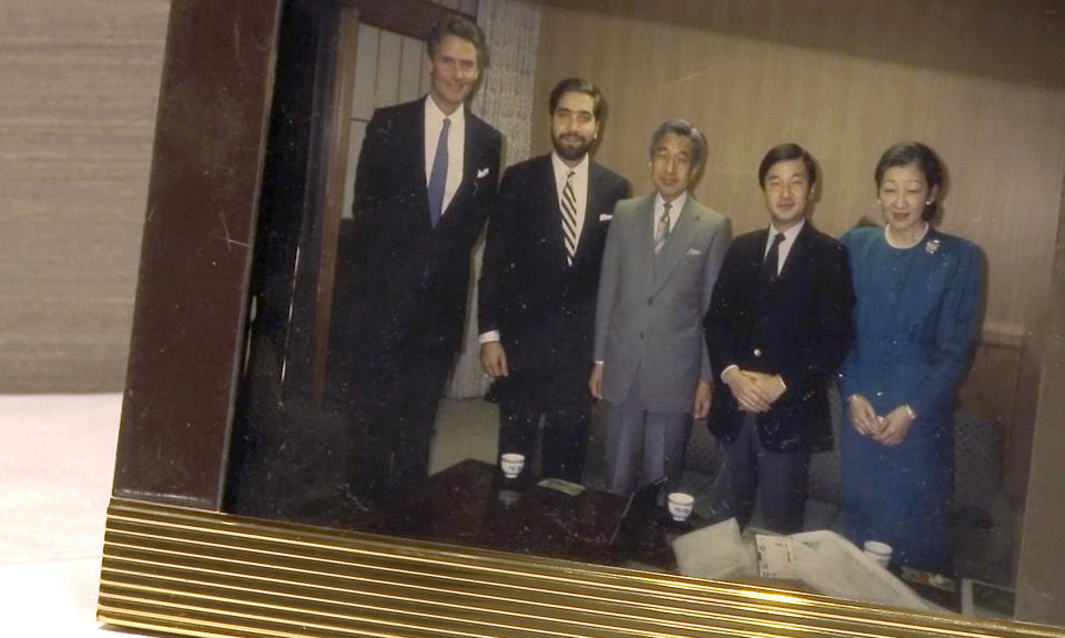 In this image, a photo captured in the April 5, 2019, video, Japan's Crown Prince Naruhito, second from right, Emperor Akihito, center, and Empress Michiko, right, pose with Naruhito's friend Keith George, second from left, and then West Virginia Gov. Gaston Caperton, left, at Tokyo’ Imperial Palace in 1990. George, a friend of Naruhito’s since their days at Oxford in 1980s, and Gov. Caperton visited Japan on a state's trade mission in 1990. The video was filmed during George's interview by The Associated Press in Charleston, West Virginia. (AP Photo/Sarah Blake Morgan)