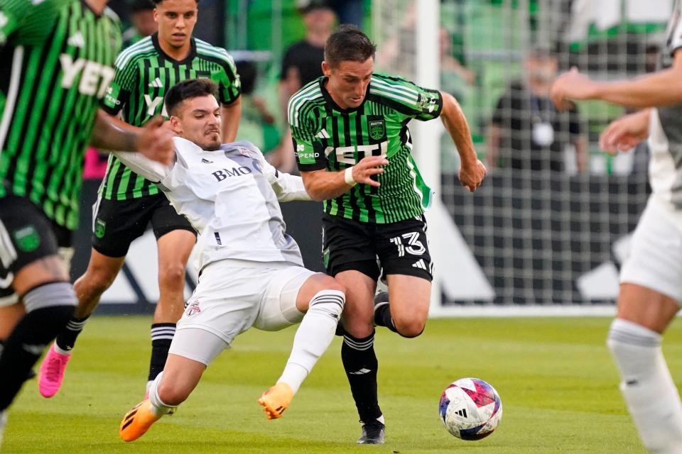 Toronto FC defender Raoul Petretta and Austin FC midfielder Ethan Finlay battle for the ball during the first half of Saturday's contest. El Tree's second straight win saw the club move up to ninth place in the Western Conference.