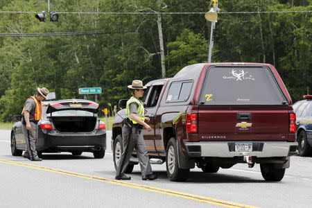 New York State Troopers search vehicles at a check point near Dannemora, New York June 8, 2015. REUTERS/Chris Wattie