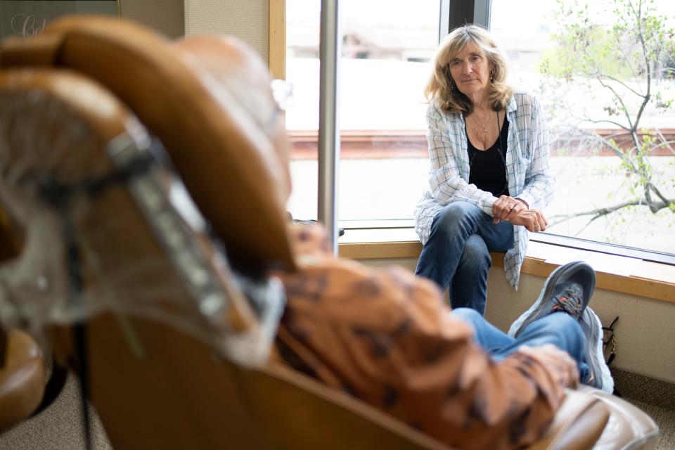 After telling him that the dentist appointment was her own just to get him to the office, Suzi Hanna sits beside her husband, Jack, as the dentist prepares to repair a crown and cavity in Jack’s mouth.