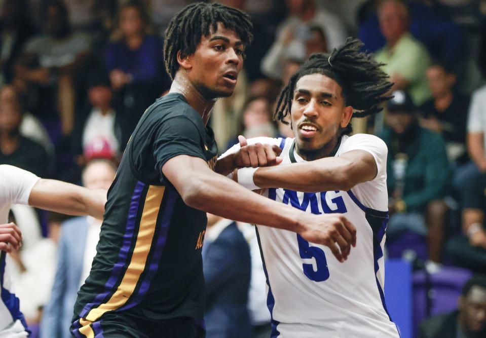Montverde Academy forward Sean Stewart (left) and IMG Academy forward Amier Ali (right) battle for position during the second half of the Sunshine Classic basketball tournament at Mills Championship Court on the campus of Montverde Academy.