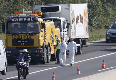 A truck in which up to 50 migrants were found dead, is prepared to be towed away on a motorway near Parndorf, Austria August 27, 2015. REUTERS/Heinz-Peter Bader