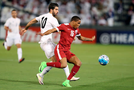 Football Soccer - Qatar v Iran - 2018 World Cup Qualifiers - Doha, Qatar - 23/3/17 - Qatar's Pedro Correia fights for the ball with Iran's Karim Ansarifard (L). REUTERS/Ibraheem Al Omari