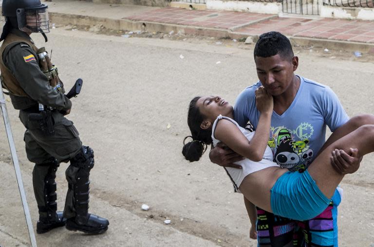 A teenage girl is brought to hospital in Carmen de Bolivar, Bolivar Province, Colombia, after fainting on September 3, 2014