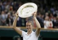 Petra Kvitova of Czech Republic holds up the winner's trophy, the Venus Rosewater Dish, after defeating Eugenie Bouchard of Canada in their women's singles final tennis match at the Wimbledon Tennis Championships in London July 5, 2014. REUTERS/Stefan Wermuth