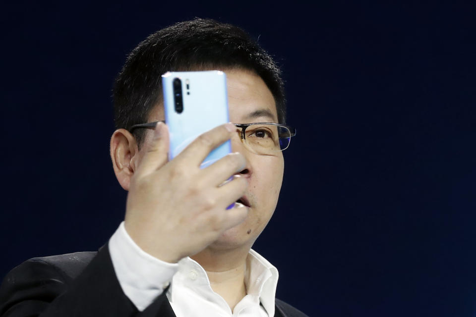 Huawei CEO Richard Yu displays the new Huawei P30 smartphone during a presentation, in Paris, Tuesday, March 26, 2019. (AP Photo/Thibault Camus)