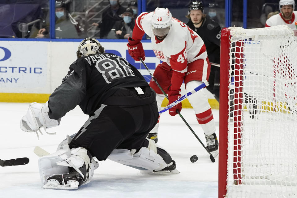 Detroit Red Wings left wing Givani Smith (48) tries to get off a shot on Tampa Bay Lightning goaltender Andrei Vasilevskiy (88) during the first period of an NHL hockey game Saturday, April 3, 2021, in Tampa, Fla. (AP Photo/Chris O'Meara)