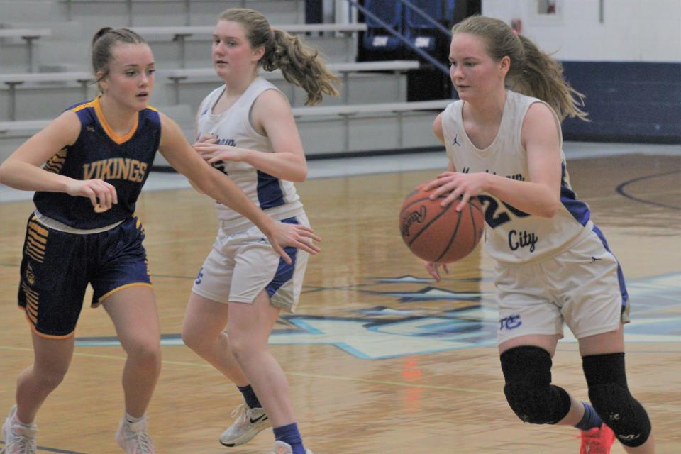 Mackinaw City senior Gracie Beauchamp (right) moves around a pick set by freshman teammate Kenzlie Currie during the second half of Thursday's girls basketball contest against Alanson in Mackinaw City.