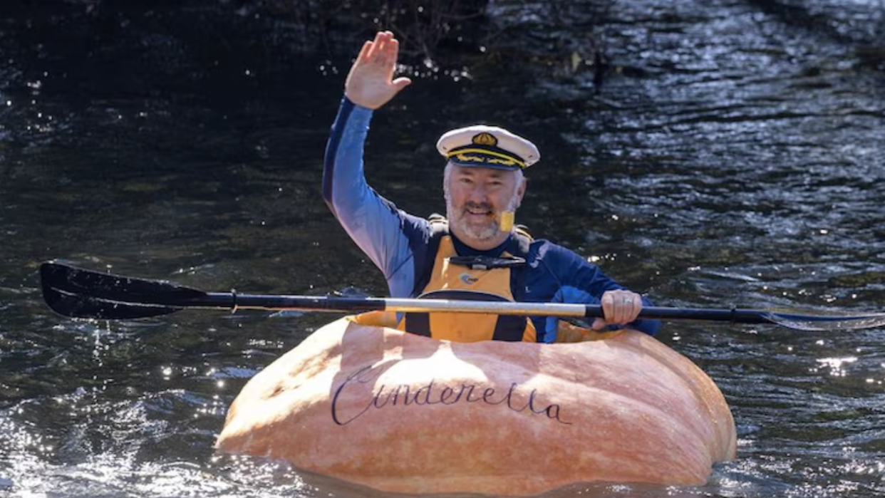  Man dressed as Popeye paddling down Australian river in a giant pumpkin called Tormund. 