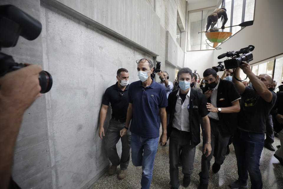 Shmulik Peleg, maternal grandfather of Eitan Biran, who survived a cable car crash in Italy that killed his immediate family, leaves court in Tel Aviv on Thursday, Sept. 23, 2021 for a hearing on charges of kidnapping his grandson. The boy's parents and younger sibling were among 14 killed in May when a cable car slammed into a mountainside in northern Italy. He is now the focus of a custody battle between his maternal grandparents in Israel and his paternal relatives in Italy. (AP Photo/Sebastian Scheiner)