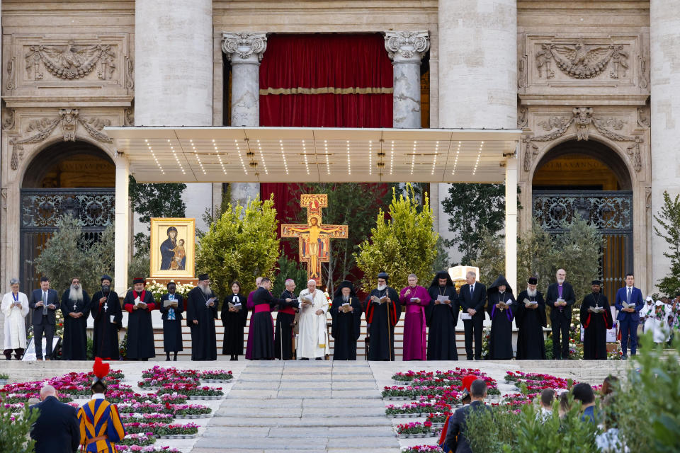 FILE - Pope Francis standing with church leaders in front of a replica of the icon 'Maria Salus populi romani'' and the St. Damian crucifix, blesses the participants into "Together", a vigil prayer for the Synod of Bishops in St. Peter's Square at The Vatican, Saturday, Sept. 30, 2023, three days ahead of the official opening of the XVI Assembly of the Synod of Bishops on 4 October. Pope Francis is convening a global gathering of bishops and laypeople to discuss the future of the Catholic Church, including some hot-button issues that have previously been considered off the table for discussion. Key agenda items include women's role in the church, welcoming LGBTQ+ Catholics and how bishops exercise authority. For the first time, women and laypeople can vote on specific proposals alongside bishops. (AP Photo/Riccardo De Luca, File)