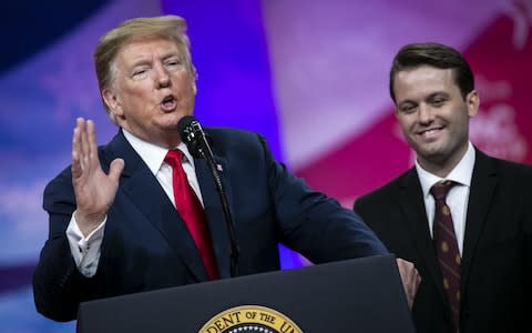 U.S. President Donald Trump, left, speaks as Hayden Williams, a member of the Leadership Institute, listens during the Conservative Political Action Conference - Credit: Bloomberg